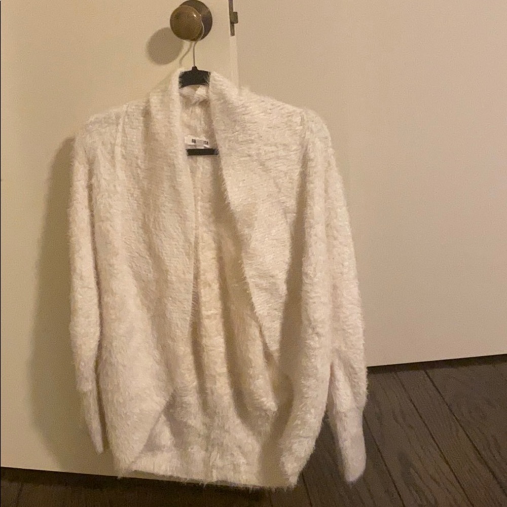 Fuzzy cream sweater. Barely works.